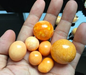 Exquisite 139.45 Carat Deep Orange Round Melo Melo Pearl